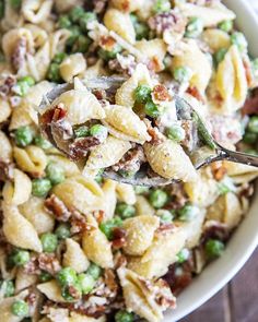 a spoon full of pasta salad with peas and bacon