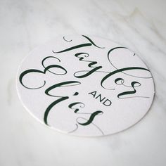 a white and green wedding sticker on a marble surface