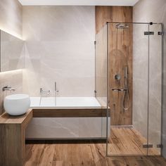 a bathroom with a tub, sink and shower stall in it's center area