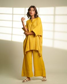 Introducing our Linen Oversized Loungewear Set - the epitome of cozy elegance for your fall wardrobe! Embrace comfort and style with this delightful ensemble featuring a loose half sleeves top and matching long pants. Crafted from the luxurious Viscose linen, this set effortlessly combines warmth and breathability for the perfect companion. Specifications: Length Top: 32 inches, Pant length: 39.5 inches Quality: Premium Linen Care: Hand wash with a touch of love or spoil it with a gentle dry clean. Ships within 3-5 working days. Need it sooner? Drop us a message for expedited delivery options. Additional Features: Colour: Dive into Jaisalmer Mustard or customize it to your heart's desire! Feel: Immerse yourself in softness and lightness. Availability: Made to order, exclusively for you. Fa Linen Tunic For Loungewear, Yellow Relaxed Fit Loungewear Sets, Yellow Relaxed Fit Lounge Sets, Oversized Lagenlook Tunic For Loungewear, Oversized Tunic For Loungewear, Oversized Linen Tunic For Loungewear, Relaxed Linen Tunic For Loungewear, Relaxed Fit Linen Tunic For Loungewear, Oversized Loungewear