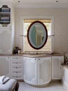 a bathroom with a sink, mirror and bathtub in the corner next to a window