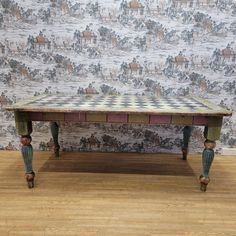 a chess board on top of a table in front of a wallpapered background