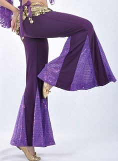 a woman in purple belly dance outfit posing