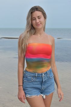 Paint your summer with vibrant hues in this eye-catching tube top, inspired by the breathtaking spectacle of sunrise. Here's why you'll radiate confidence in this top: Glowing Colors: Capture the essence of a sun-kissed morning with a palette of [insert specific colors, e.g., golden orange, fiery pink, soft coral]. Each shade seamlessly blends, mimicking the gradient of a rising sun. Flattering Fit: The classic tube top silhouette hugs your curves comfortably, while adjustable strapsensure a per Trendy Bandeau Tube Top For Beach Season, Trendy Strapless Tube Top For Beach Season, Stretch Strapless Tube Top For Summer, Strapless Tank Top For Beach Season Vacation, Strapless Tank Top For Beach Vacation, Stretch Summer Tube Top, Summer Strapless Tank Top For Beach, Strapless Summer Tank Top For Beach, Summer Strapless Beachwear Tops