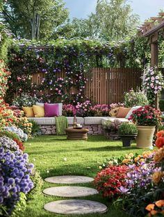 an outdoor seating area with lots of flowers on the grass and trees in the background