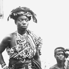 an old black and white photo of two women in native garb standing next to each other