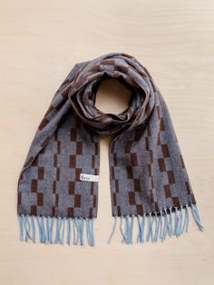 Elevate your outfit with a fringed TBCo lambswool scarf featuring a stacked checker pattern in a blend of blue & brown. Taking the best from both, it's a modern combination of our well-loved striped and checkerboard designs. It's woven from pure lambswool, which is famously insulating, warm, breathable, sustainable and beautifully soft. Materials: Fibre, 100% Lambswool. Size: 20" x 79" / 50c00cm, including fringing. Care: Handwash. Lay Flat to Dry. Designed in Edinburgh studio. Alpaca Blanket, Checker Pattern, Tartan Blanket, Luxury Gifts For Her, Sleep Accessories, Cashmere Blanket, Stocking Filler Gifts, Pajamas Gift, Baby Gift Box