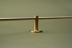 a close up of a metal bar on a green surface with no one around it