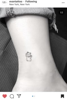 a small cat tattoo on the ankle