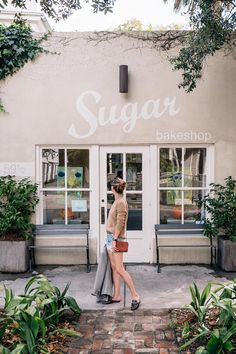 a woman standing in front of a store