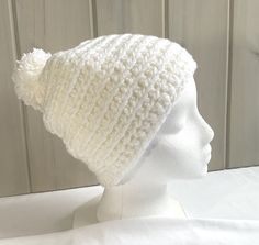 a white knitted hat on a mannequin head