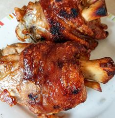 two pieces of meat sitting on top of a white plate