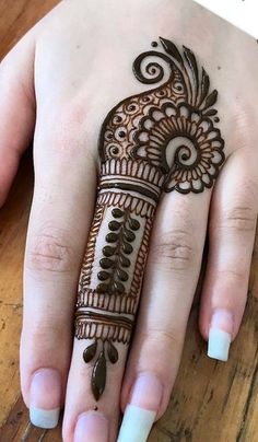 a woman's hand with hennap on it, showing the intricate design