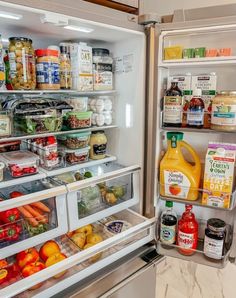 an open refrigerator filled with lots of food and condiments on the shelves,