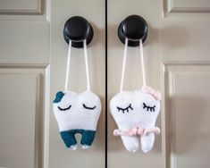 two stuffed toothbrushes hanging from hooks on a door