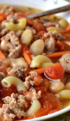 a white bowl filled with pasta and meat soup