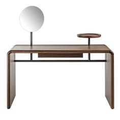 a wooden desk with a mirror on the top and a shelf below it that holds a round mirror