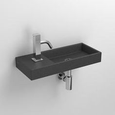 a bathroom sink with a faucet and soap dispenser on the wall