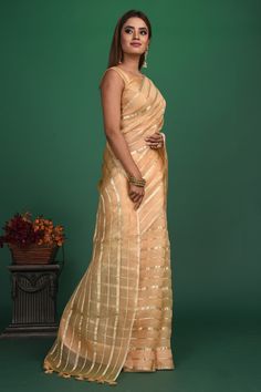 Slay with your elegance on special occasions in this alluring cream organza saree. The saree is enhanced with golden stripes. It comes with a stunning multicolor saree blouse. Shop designer sarees online in USA from Pure Elegance. Disclaimer: The shown stitched blouse on the model is for display purpose only. The saree comes with a matching blouse and finished with fall and piko. Multicolor Saree, Sarees Party Wear, Bollywood Sarees, Multicolor Blouse, Multi Color Blouse, Pure Elegance, Fashion Journals, Designer Sarees Online, Indian Saree