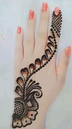 a woman's hand with henna tattoos on it