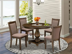 a round dining table with four chairs around it