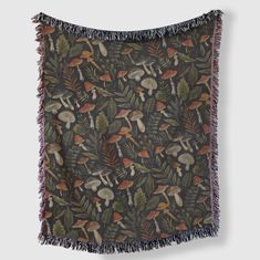 a tapestry with mushrooms and leaves is hanging on a wall in front of a gray background