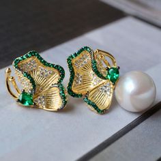 💚💚 Specifics: Materials: Natural freshwater Pearl With 925 Silver And Zircon Earrings Size: 12mm*22mm Pearl Diameter: 10mm*10mm Closure: the closure is made of 925 sterling silver.  Handmade Artwork, original design and copyright protected  Metal: Gold plated s925 silver 💚💚Shipping We ship it in 5-7 days after the payment is made and you may choose your personalized shipping services. We shipping world wide and it is free international shipping. Please kindly be reminded that we are not resp Elegant Green Round Clip-on Earrings, Elegant Green Round Bridal Earrings, Elegant Green Flower Shaped Jewelry, Elegant Green Flower-shaped Jewelry, Elegant Green Pearl Earrings For Pierced Ears, Elegant Green Clip-on Earrings, Green Pearl Drop Earrings As Gift, Green Pearl Drop Earrings For Anniversary, Green Pearl Drop Earrings For Gift