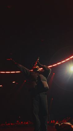 a man standing on top of a stage holding a microphone