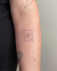 a woman's arm with a tattoo on it and a stamp that says love