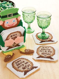 the st patrick's day coasters are decorated with cross - stitch designs and glassware