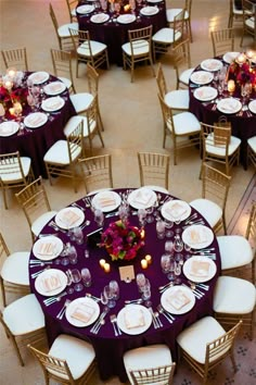 an overhead view of tables and chairs with purple linens