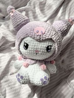 a crocheted stuffed animal laying on top of a bed