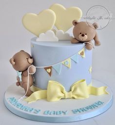 a baby shower cake with two teddy bears on top