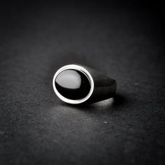 A handmade sterling silver 925 oval shaped black onyx stone signet ring.Each ring is cleaned and polished with care.The weight of the ring may vary according to size.Top measurements: Width - 18.7mm | Height - 15.4mmApprox weight: 7.96grThe ring is set with one horizontal oval shaped black onyx stone.*The ring is hollowed out from the inside*This ring is made to order! Please allow up to 21 business days to be made before shipment. If you have any further questions, please don’t hesitate to cont Modern Onyx Signet Ring With Polished Finish, Modern Oval Black Enamel Rings, Timeless Onyx Signet Ring With Polished Finish, Elegant Black Dome Ring With Polished Finish, Classic Black Sterling Silver Signet Ring, Modern Black Dome Ring As A Gift, Modern Black Oval Signet Ring, Classic Oval Black Enamel Signet Ring, Modern Black Dome Ring Gift