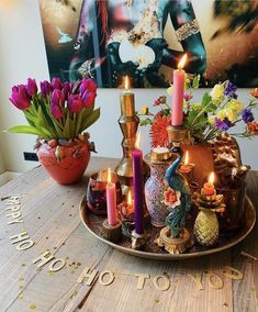 a table topped with lots of candles and vases