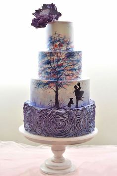 a three tiered cake with an artistic design on it