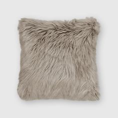 a gray pillow with long fur on it