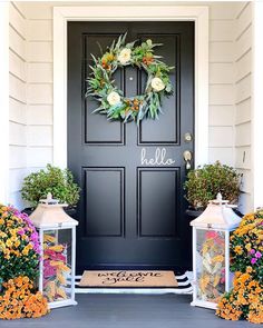 the front door is decorated with flowers and lanterns