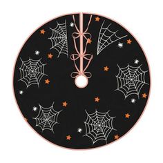 a black and orange clock with spider webs on it's face, surrounded by stars