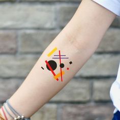 a woman's arm with a tattoo on it that has geometric shapes and lines