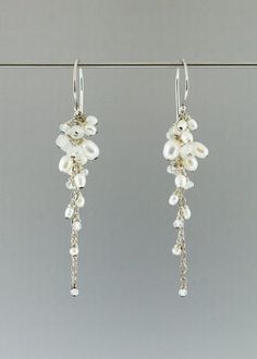 two pairs of earrings with pearls hanging from them