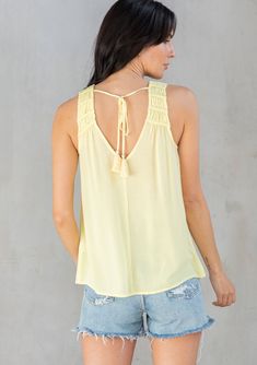 We love this dreamy tank top for its flattering relaxed fit and light-as-air crepe fabrication. The braided trim and tassel ties add a bohemian feel. Perfect for day or night, this effortless top pairs well with denim. Braided trim Relaxed fit Sleeveless Round hemline V-neckline in front and back Tassel tie closure at the back Sheer Elevated basics Model is 5'9, wearing a size S in Black and Blue Fog. Model is 5'10, wearing a size S in Yellow.Style: I-13697W-RQW Summer V-neck Top With Tassels, Summer V-neck Tops With Tassels, Chic Rayon Tank Top For Beach, Summer Rayon Tank Top For Vacation, Chic Vacation Tank Top With Smocked Back, Bohemian Sleeveless Top With Tie Straps, Bohemian Tie Back Top For Day Out, Bohemian Blouse With Smocked Back For Beach, Bohemian Tops With Tie Straps For Day Out