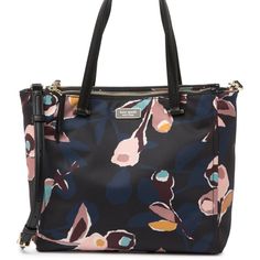 Abstract Floral Print Details The Exterior Of A Textile Constructed Satchel That Features Various Organizational Compartments And Pockets, And Contrasting Leather Top Handles. - Detachable, Adjustable Shoulder Strap - Magnetic Button Tab Closure - Interior Features 2 Outer Zip Compartments, 1 Wall Zip Pocket, And 2 Media Pockets - Approx. 10" H X 10.5" W X 4" D - Approx. 7" Handle Drop, 19-24" Shoulder Strap Drop - Materials : Textile Exterior And Lining, Leather Trim