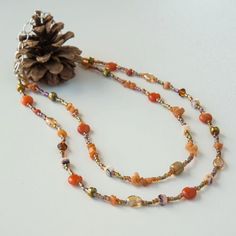 Autumn is just around the corner! This double-strand beaded necklace is made of red agate stones, aventurine chips, Czech glass, crystal, glass seed beads and silver-tone accent beads. It is finished with silver-tone stainless steel chain. Handmade Orange Double Strand Necklace, Orange Multi-strand Polished Beaded Necklaces, Orange Multi-strand Beaded Necklace With Polished Beads, Orange Multi-strand Polished Beaded Necklace, Orange Czech Glass Beaded Necklaces, Orange Carnelian Beaded Necklace With Colorful Beads, Orange Beaded Necklaces With Czech Glass, Orange Czech Glass Beaded Necklace, Amber Czech Glass Beaded Necklace With Gemstone Beads