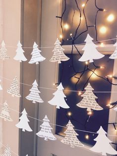 paper christmas trees are strung with string lights