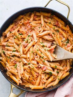 a skillet filled with pasta and sauce