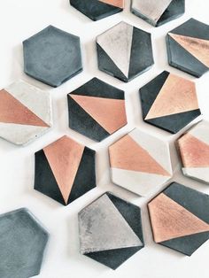 several hexagonal shapes are arranged on a white surface with copper and black accents