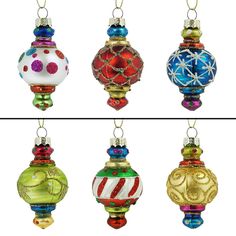 four different colored glass ornaments hanging from chains on a white background, each decorated with an ornament and snowflakes