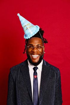 a man in a suit and tie with a party hat on top of his head