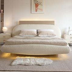 a white bed sitting in a bedroom on top of a rug